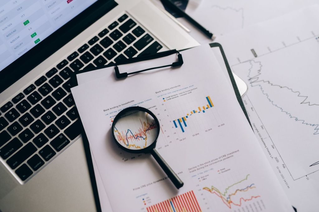 A magnifying glass resting on a printed sheet of statistics